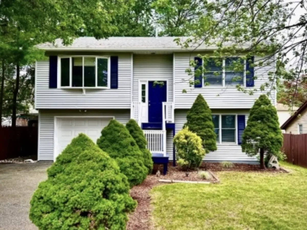 589 Lake Shore Drive, Parsippany-Troy Hills NJ — renovated 2-story custom home near Lake Parsippany with navy shutters and mature landscaping. Listed and rented by BB Angjushev for $3,900/month.
